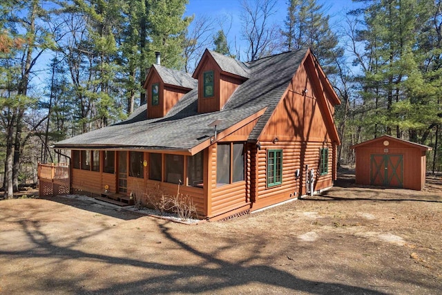 W3864 W Lemonweir Ct, Mauston, WI 53948 - exterior space with a storage unit, an outbuilding, and a shingled roof