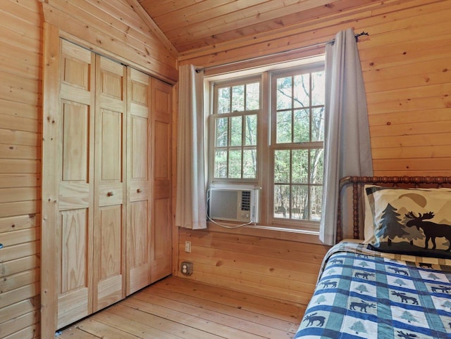 W3864 W Lemonweir Ct, Mauston, WI 53948 - bedroom with cooling unit, lofted ceiling, light wood-style flooring, and wooden walls