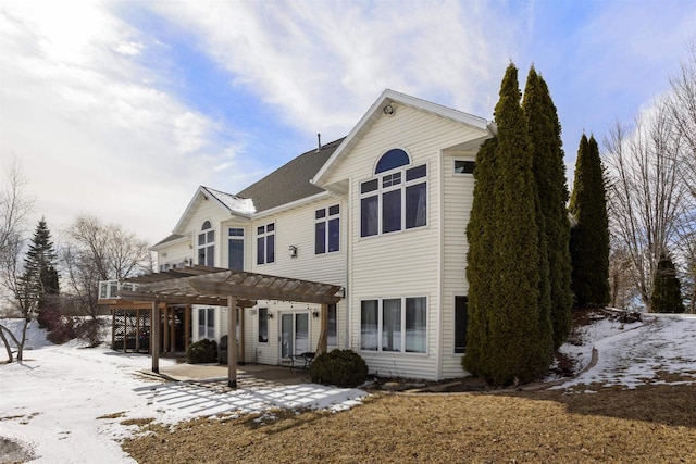 snow covered property featuring a patio area and a pergola