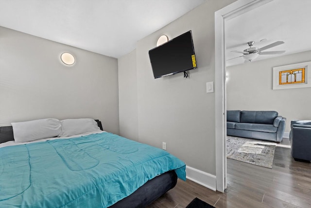 bedroom with baseboards and wood finished floors