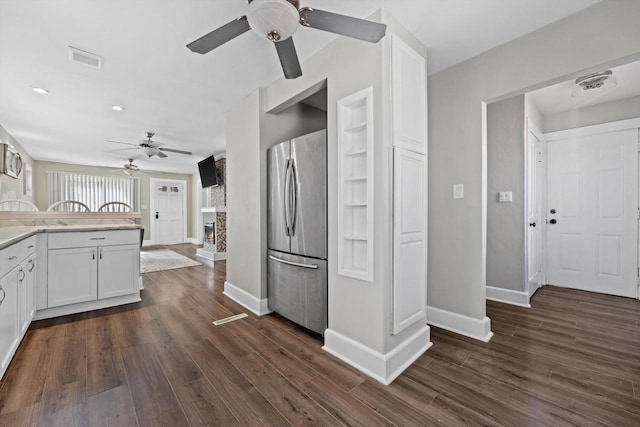 kitchen featuring visible vents, dark wood-style floors, white cabinetry, freestanding refrigerator, and light countertops