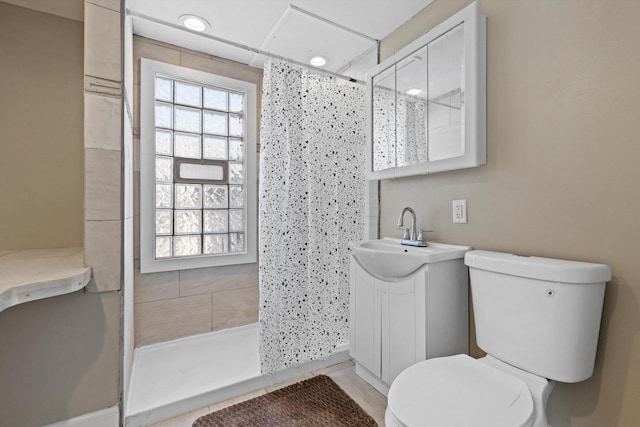 full bath featuring recessed lighting, vanity, toilet, and a shower stall