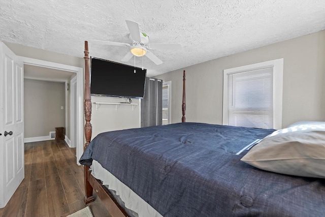 bedroom with visible vents, a ceiling fan, a textured ceiling, wood finished floors, and baseboards