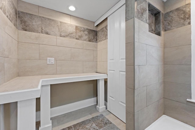 full bathroom with recessed lighting and tiled shower