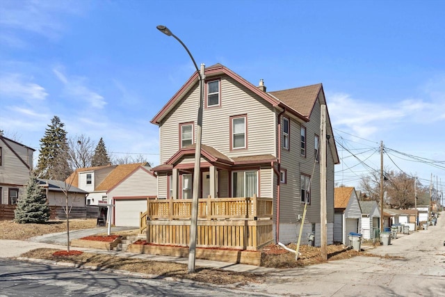 view of front of house with a residential view, covered porch, a chimney, and a garage