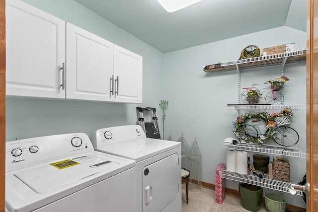 laundry area with washing machine and dryer, cabinet space, and baseboards