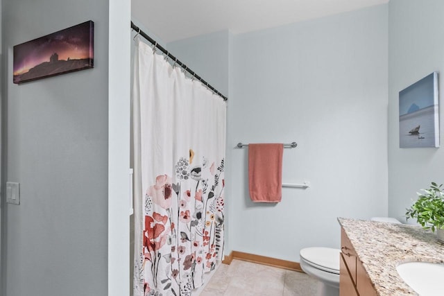 bathroom with vanity, a shower with curtain, baseboards, tile patterned floors, and toilet