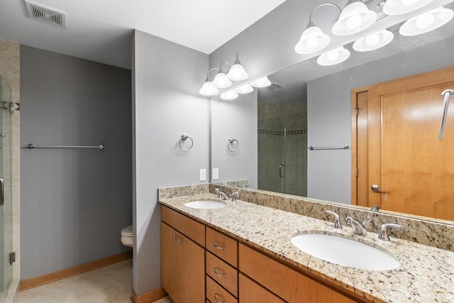 bathroom featuring visible vents, a stall shower, toilet, and a sink