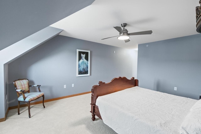 carpeted bedroom featuring vaulted ceiling, baseboards, and ceiling fan