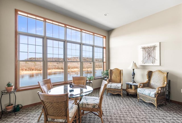 interior space featuring baseboards and a water view