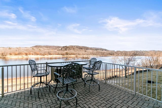 view of patio / terrace with a water view and fence