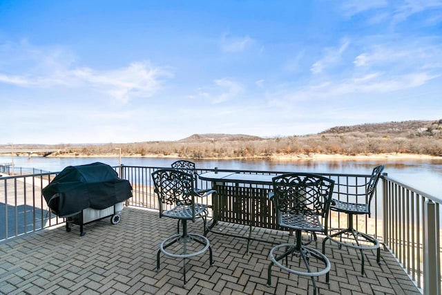 view of patio featuring a water view and area for grilling