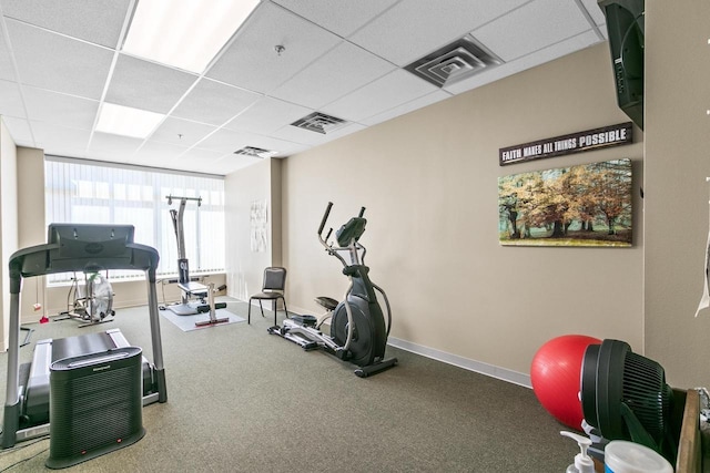 interior space with baseboards, visible vents, and a drop ceiling