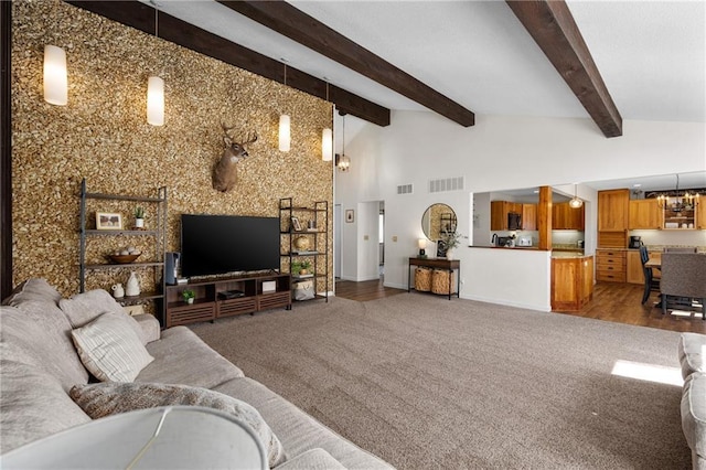 living room featuring visible vents, a chandelier, carpet floors, beam ceiling, and high vaulted ceiling