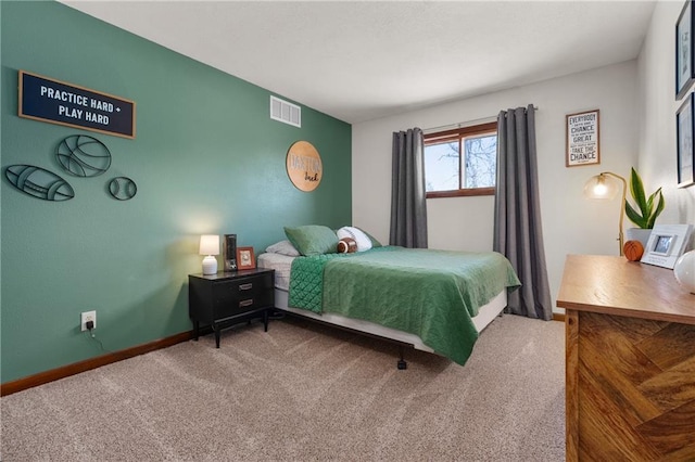 carpeted bedroom featuring visible vents and baseboards