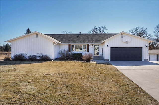 view of front of house with a front yard, an attached garage, and driveway