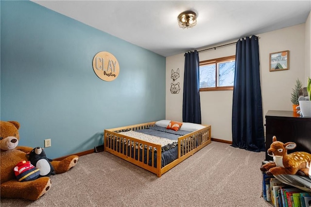 carpeted bedroom featuring baseboards