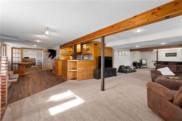 carpeted living area with beamed ceiling, recessed lighting, and a textured ceiling