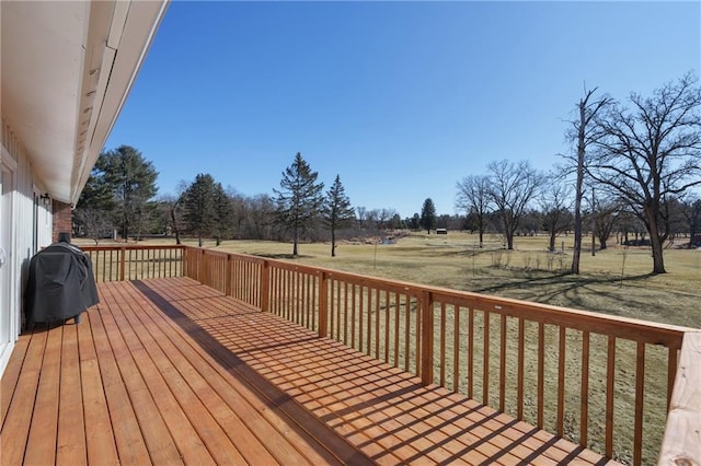 wooden deck with grilling area and a lawn