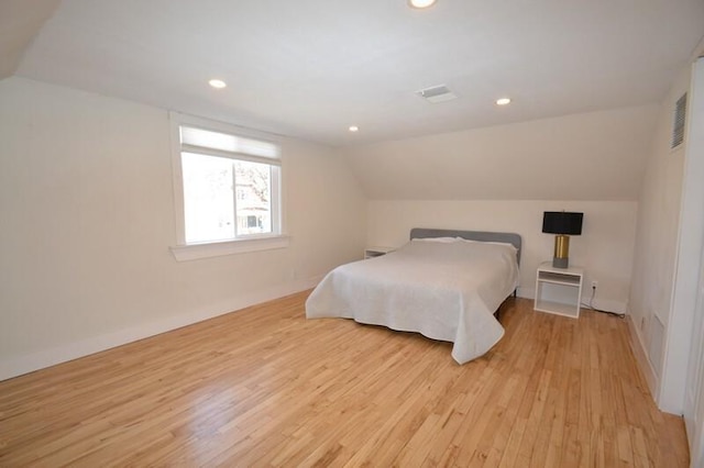 bedroom with recessed lighting, visible vents, light wood-style flooring, and vaulted ceiling