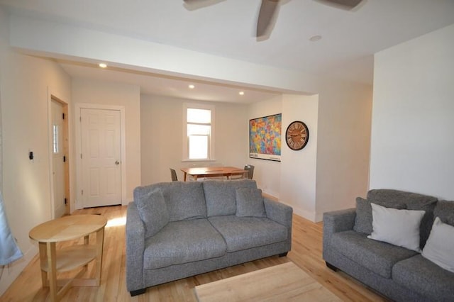 living area with recessed lighting, baseboards, and light wood finished floors