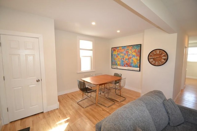 dining room with a healthy amount of sunlight, light wood-type flooring, and baseboards