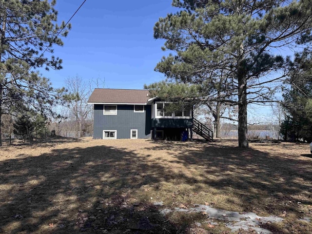 rear view of property with stairs