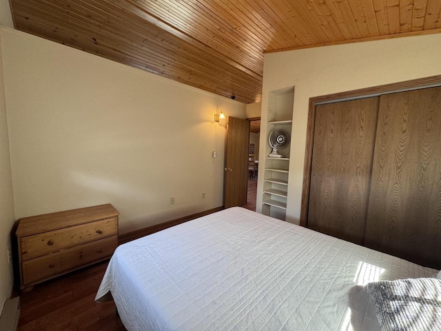 bedroom featuring lofted ceiling, wood finished floors, wood ceiling, and a closet