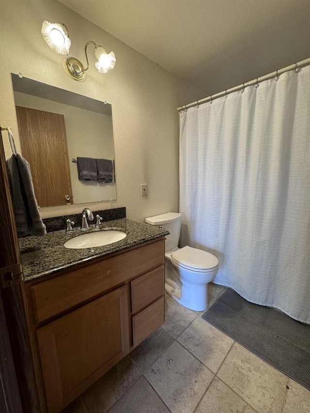 full bathroom with tile patterned flooring, toilet, and vanity