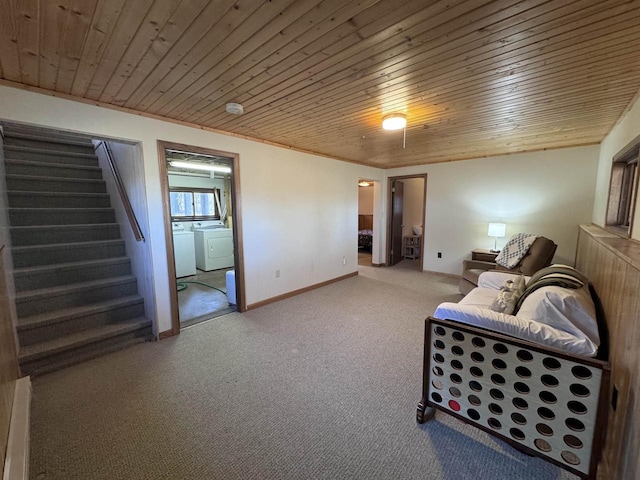 interior space with baseboards, stairs, wooden ceiling, carpet flooring, and washing machine and dryer