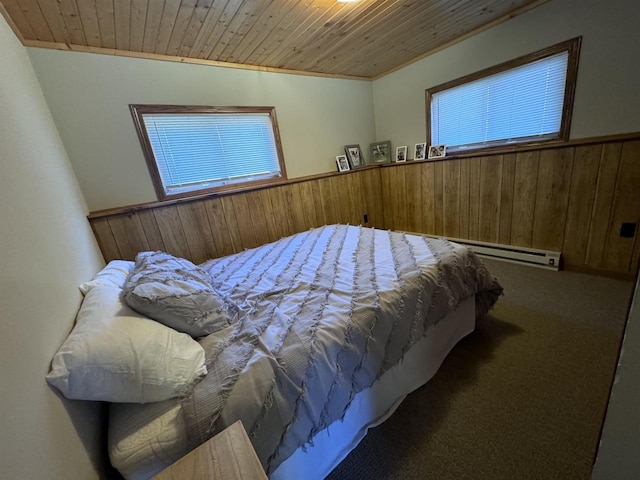 carpeted bedroom with multiple windows, wood ceiling, wood walls, and wainscoting