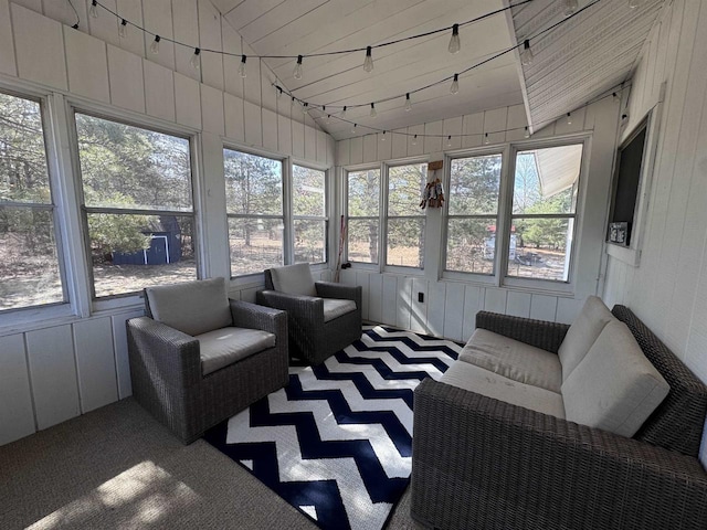 sunroom with track lighting and vaulted ceiling