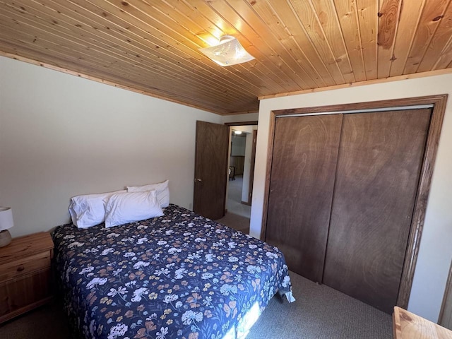 carpeted bedroom featuring wood ceiling and a closet