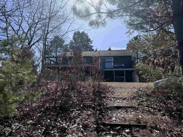 rear view of property with a balcony