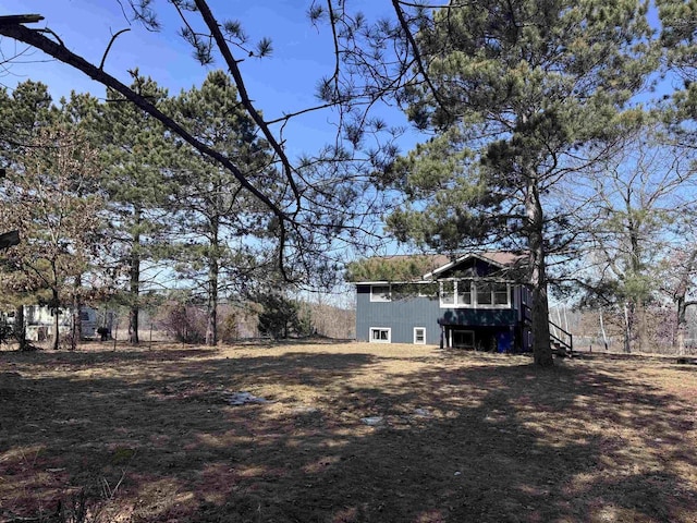 view of yard featuring a deck and stairs