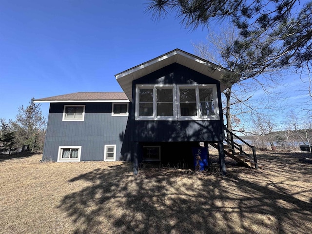 rear view of house featuring stairs