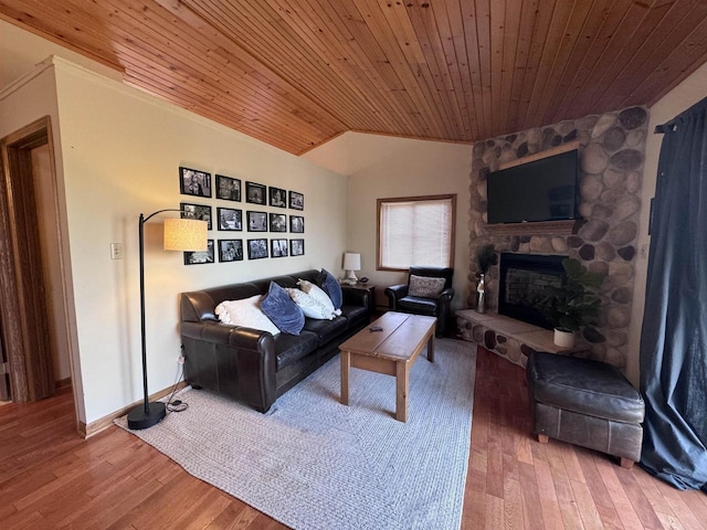 living area with wood finished floors, lofted ceiling, wooden ceiling, and a fireplace