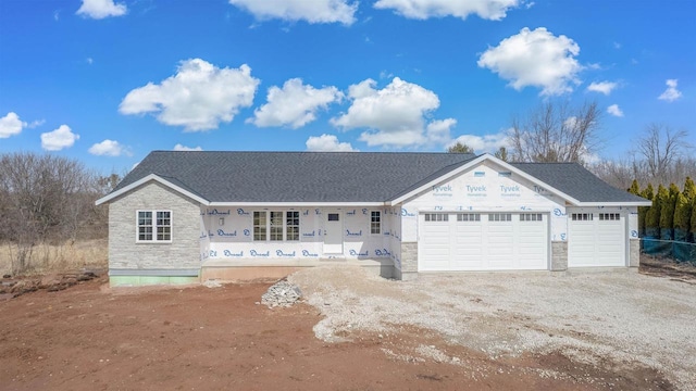 property under construction featuring stone siding, a garage, and dirt driveway