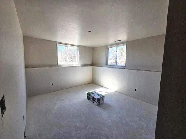 unfurnished room featuring plenty of natural light