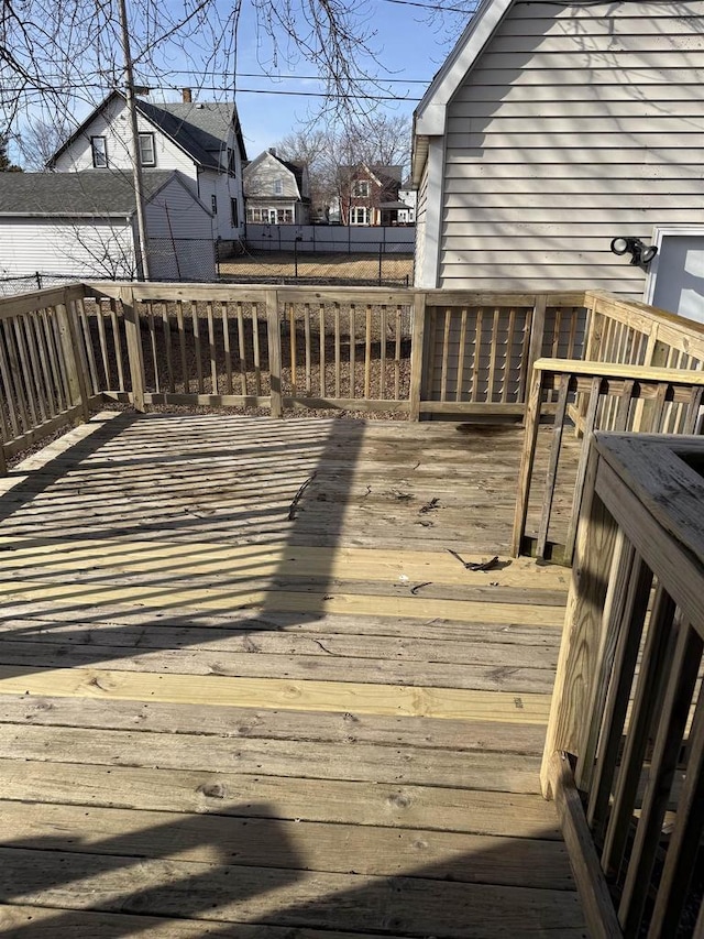 wooden deck featuring a residential view and fence