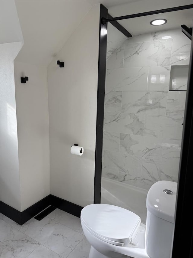 bathroom featuring a shower stall, toilet, baseboards, and marble finish floor