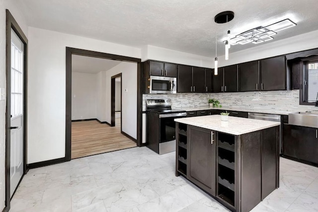 kitchen featuring marble finish floor, open shelves, backsplash, a kitchen island, and appliances with stainless steel finishes