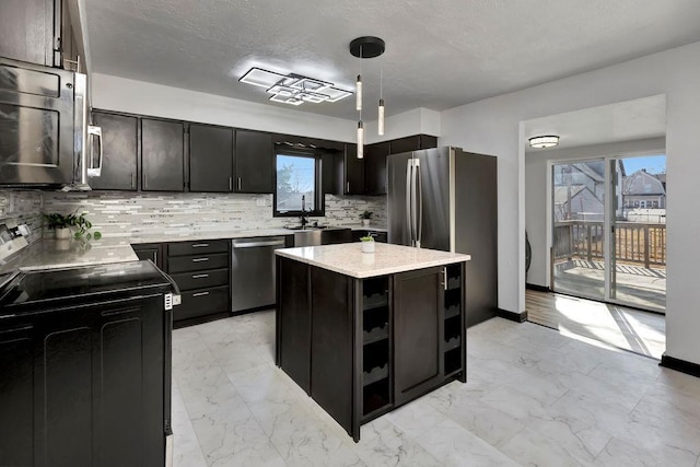 kitchen with decorative backsplash, pendant lighting, marble finish floor, and stainless steel appliances