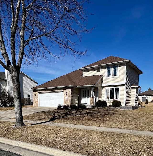 traditional-style house with an attached garage, brick siding, and driveway