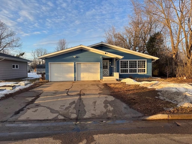 view of front of house featuring concrete driveway and a garage