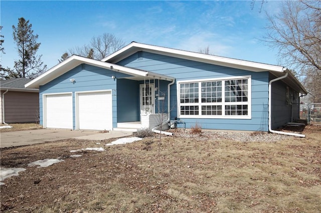 ranch-style home featuring an attached garage and concrete driveway