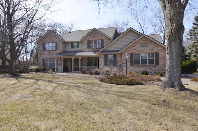 craftsman house featuring a porch, brick siding, and a front lawn