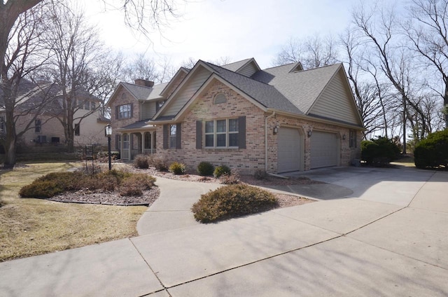 craftsman inspired home with brick siding, a shingled roof, concrete driveway, a chimney, and a garage