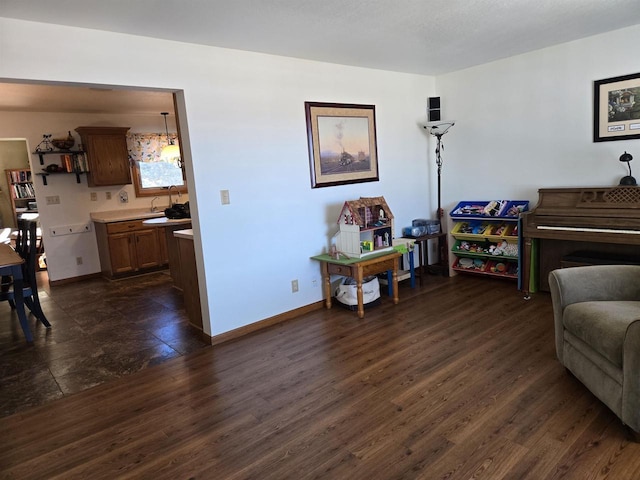 living area featuring baseboards and dark wood finished floors