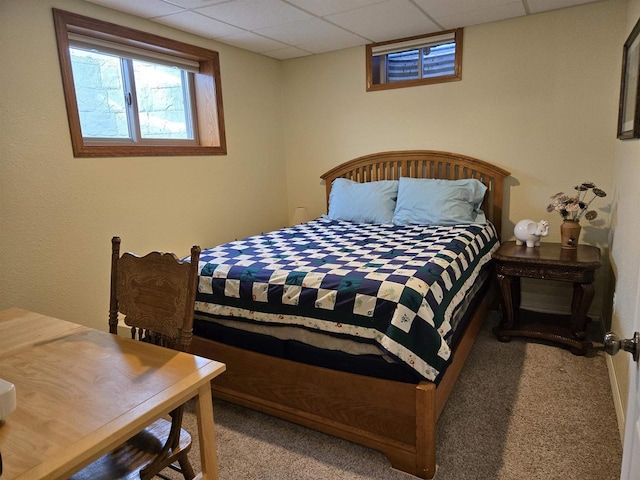 carpeted bedroom featuring a paneled ceiling